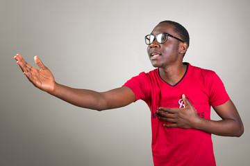 Young african man in glasses singing