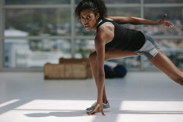 Fototapeta na wymiar Healthy african woman working out in gym
