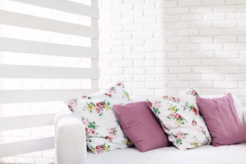 Close up of colorful pillows on sofa in modern living room