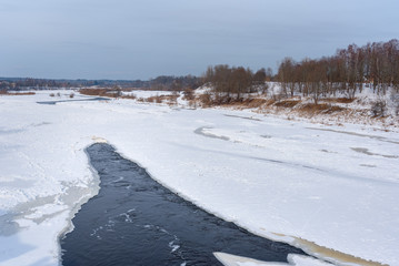 Frozen Venta river in winter at Kuldiga, Latvia.