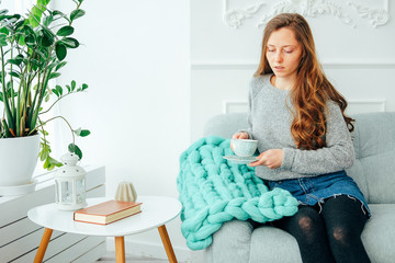 Woman in casual clothes sitting in the living room