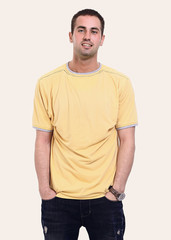 Fototapeta premium young man in a yellow t-shirt and jeans.