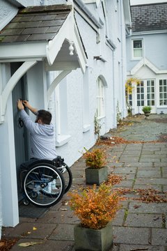 Disabled man opening the door
