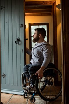 Disabled man closing the door