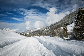 Fototapeta na wymiar Panoramic road view in Tyrollean Alps by snowy winter