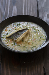 fish soup on dark background