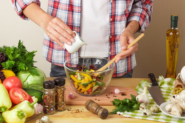 Woman cooks at the kitchen