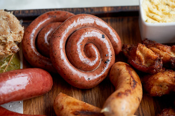 German hearty lunch in the pub. Grilled sausages, stewed cabbage, croutons, sauce. Beer snack
