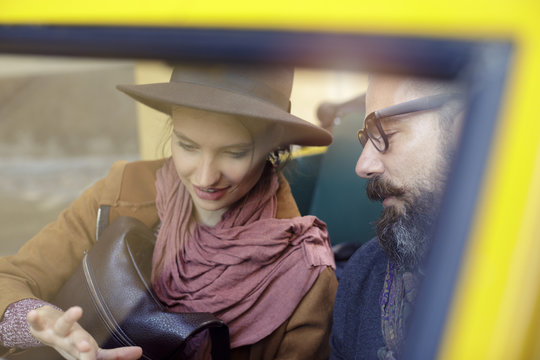 Woman and man talking looking at map.Detail on people. Caucasian couple in love roadtrip vacation italian travel on convertible car
