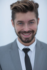 Serious businessman wearing suit and tie. blue background