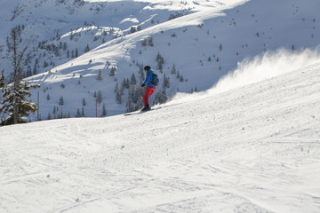 Fototapeta na wymiar Man skiing down the alpine slope. Ski slope in winter sunny day at the mountain ski resort of Alpbachtal, Wildschönau, Austria