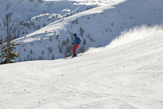 Man skiing down the alpine slope. Ski slope in winter sunny day at the mountain ski resort of Alpbachtal, Wildsch&ouml;nau, Austria