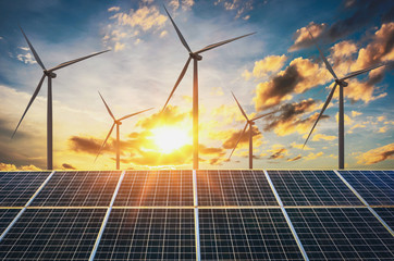 Fototapeta wind turbine with solar panels and sunset. concept clean energy obraz