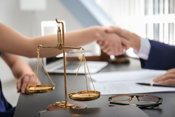 Scales of justice on table in lawyer's office