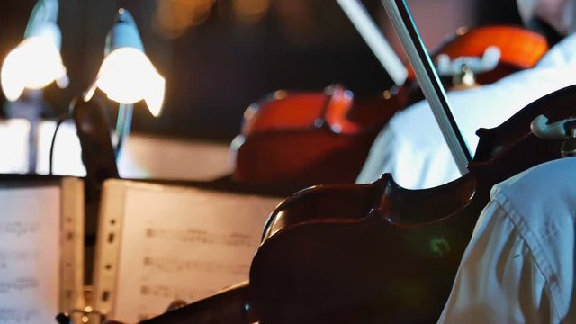 4K Musicians playing violin at a outdoor night concert