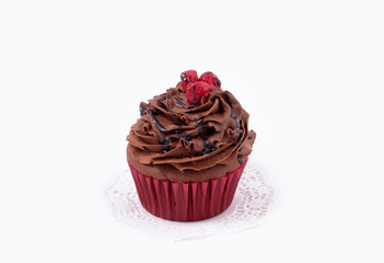 chocolate cupcake with cranberries on isolated white background