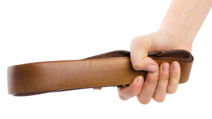 Hand holding leather belt for punishment on white background