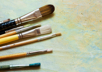 Paint brushes on an oil canvas