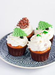 Decorated new year cupcakes on grey plate
