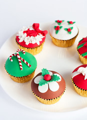 Decorated gumpaste cupcakes on white plate