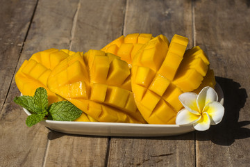 Fresh organic mango on wooden table, close up. Thailand