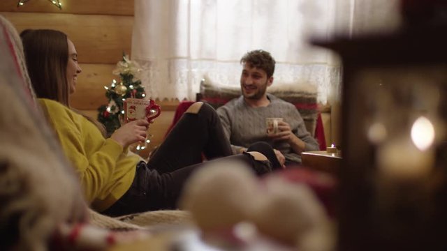 Couple kissing and relaxing inside a chalet