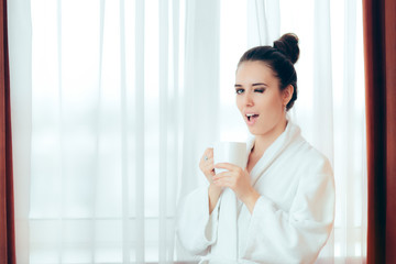 Woman in Bathrobe Starting Morning with a Cup of Coffee