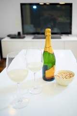 Bottle and glass of champagne in a living room