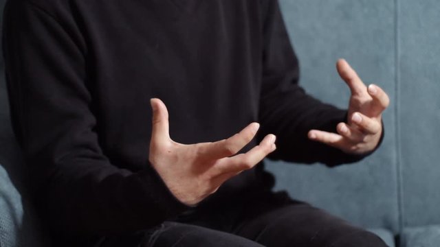 close up hands of a nervous man during psychotrapeutical session