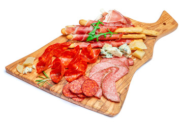 Obraz premium Cold smoked meat plate with pork chops, prosciutto, salami and bread sticks