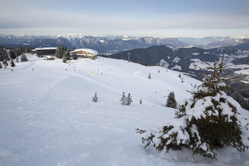 Fototapeta na wymiar Panoramic winter view of the ski slopes of ski resort at the end of the day. 