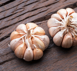 Garlic bulbs on the wooden table.