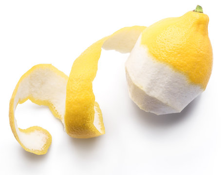 Peeled lemon and lemon zest on white background. Close-up.