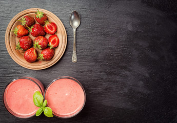 healthy strawberry yogurt with fresh berries on stone background