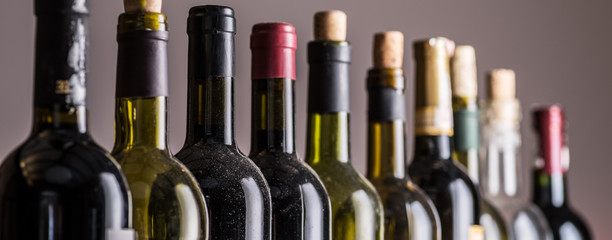 Line of wine bottles. Close-up.