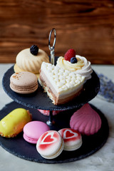 Cakes on a dark slate bunk stand. Desserts. Sweet table