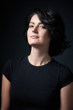 Closeup Of Bright Brunette Woman In Black Tshirt, Standing Near The Wall With Shadow