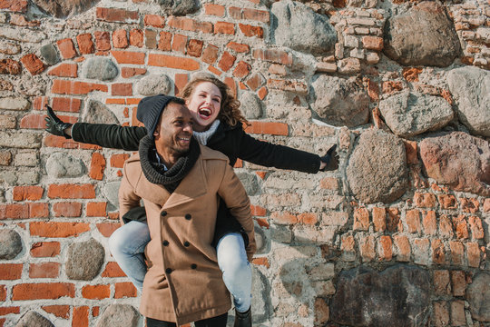 Couple having fun at brick wall