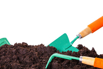 Gardening tool in soil isolated on white.