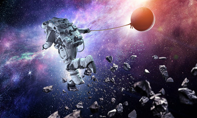 Fototapeta na wymiar Fantasy image with spaceman catch planet. Mixed media