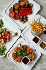 Nice table in the restaurant. Hearty and tasty lunch consisting of cheese Camembert in batter, Greek salad and grilled vegetables