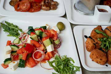 Nice table in the restaurant. Hearty and tasty lunch consisting of cheese Camembert in batter, Greek salad and grilled vegetables