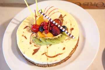 beautiful cheesecake decorated with mix fruits