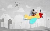 Aviator in drawn airplane. Mixed media
