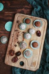 Homemade chocolate sweets on wooden cutting board