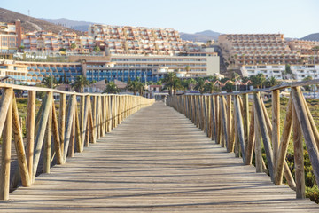 wooden walkway with fences to the Guardamar del segura beach.Alicante,Spain