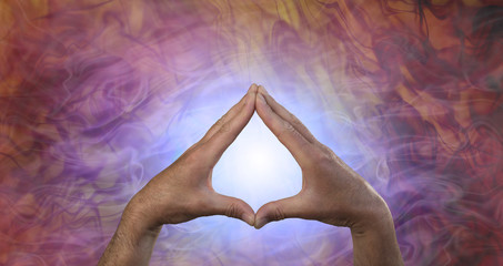 Quantum Healing Energy - male hands creating a leaf shape against a glowing blue light and flowing...