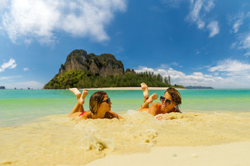 Fototapeta na wymiar Two women resting at the tropical Thailand Railay beach