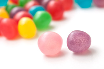 closeup of colorful round candies on white background