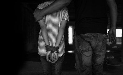 Asian girl with his hands tied in an abandoned building,stop abusing violence,human trafficking concept